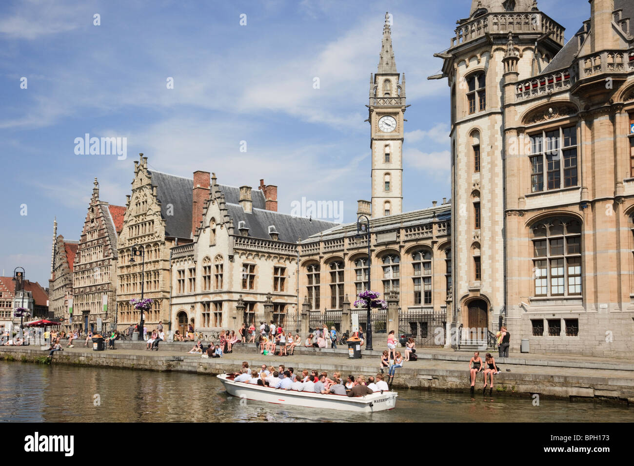 Graslei Site, Ghent, East Flanders, Belgium, Tourists in sightseeing boats on River Leie with medieval Flemish Guild houses Stock Photo