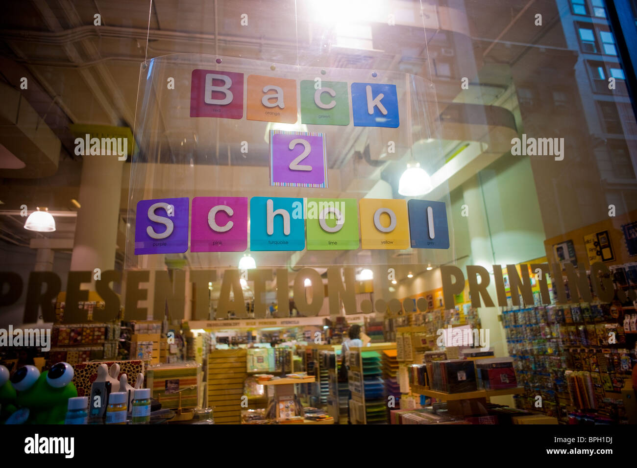 Back to school supplies are advertised in the window of an art supply