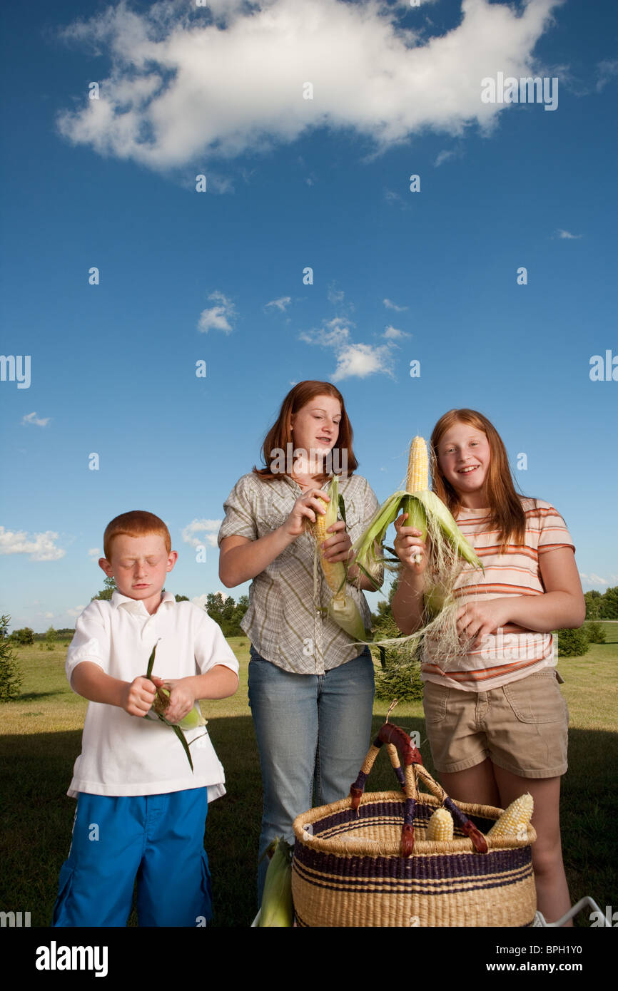 Kid shuck corn hires stock photography and images Alamy