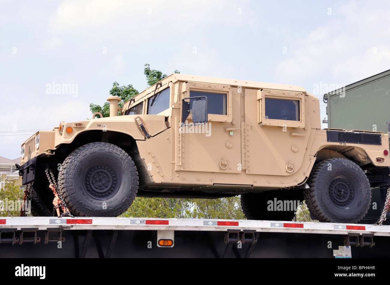 US military truck being transported on large truck Stock Photo