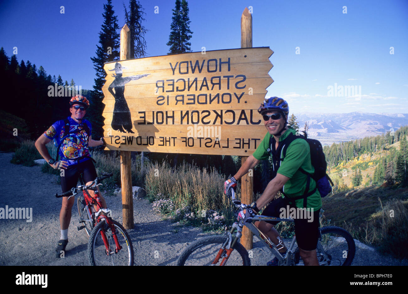 Men in front of greeting sign Stock Photo - Alamy