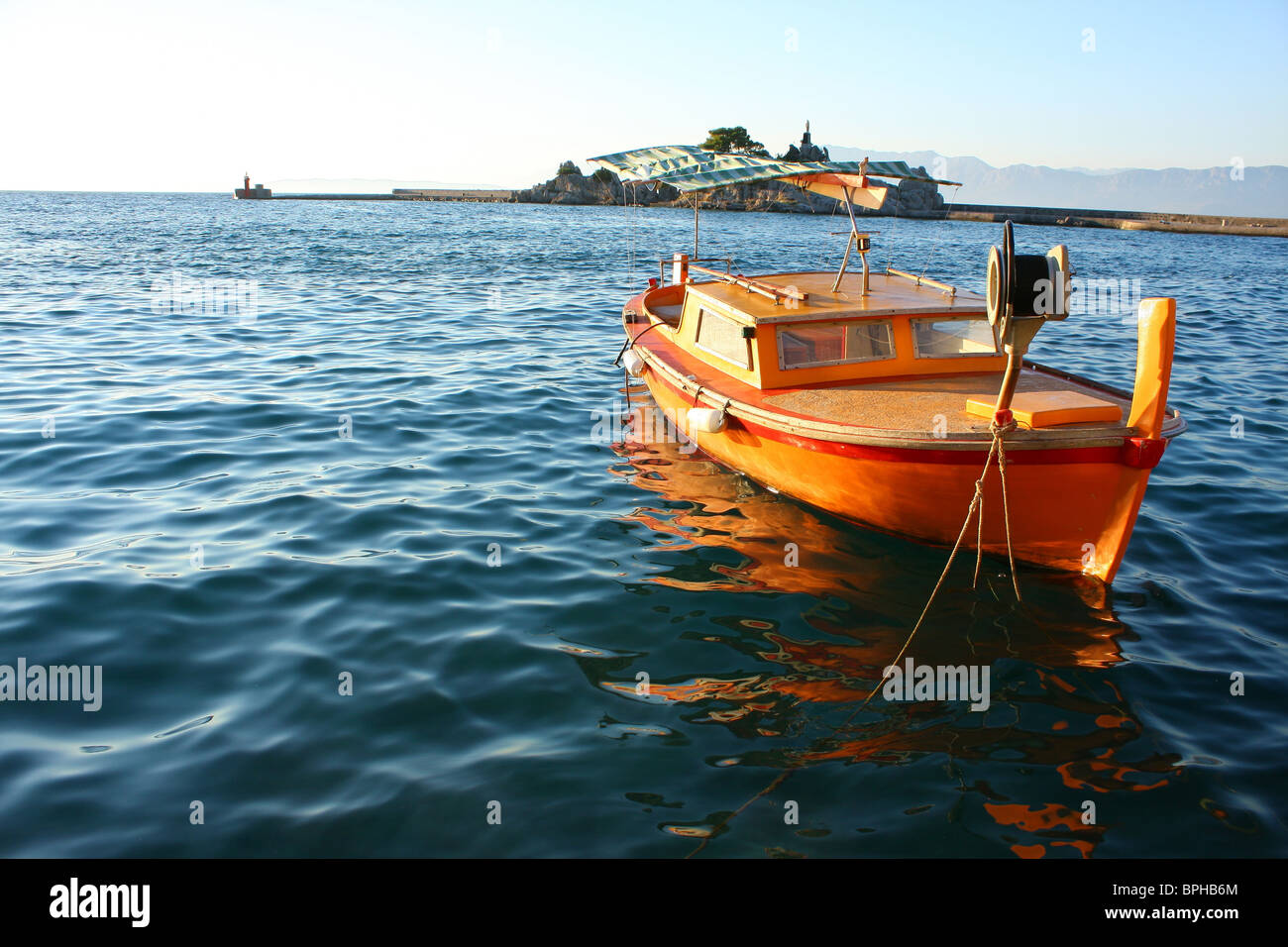 Orange boat on the sea Stock Photo