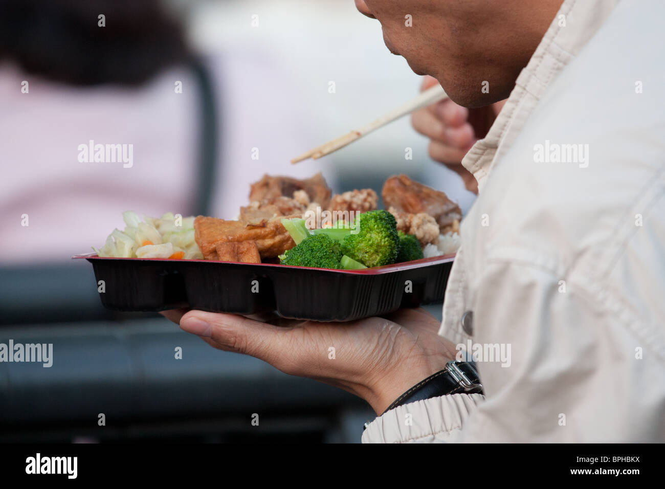 man eating Asian food chopstick Stock Photo