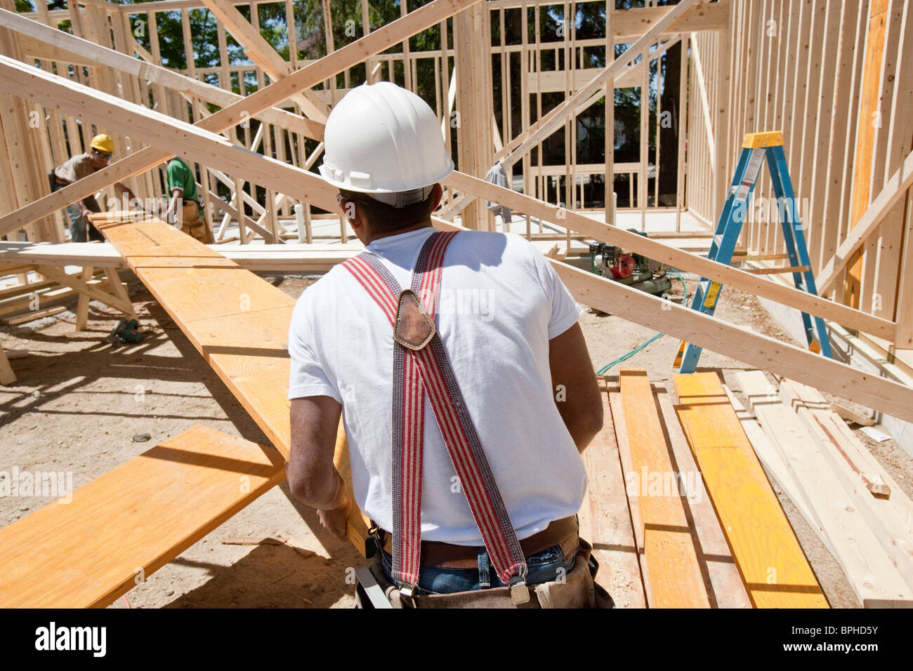 Carpenters working on a lamination beam at a construction site Stock Photo Alamy