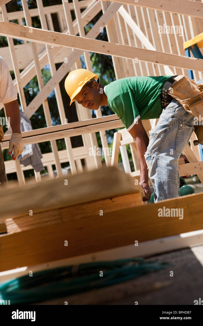 Carpenter lifting a beam Stock Photo Alamy