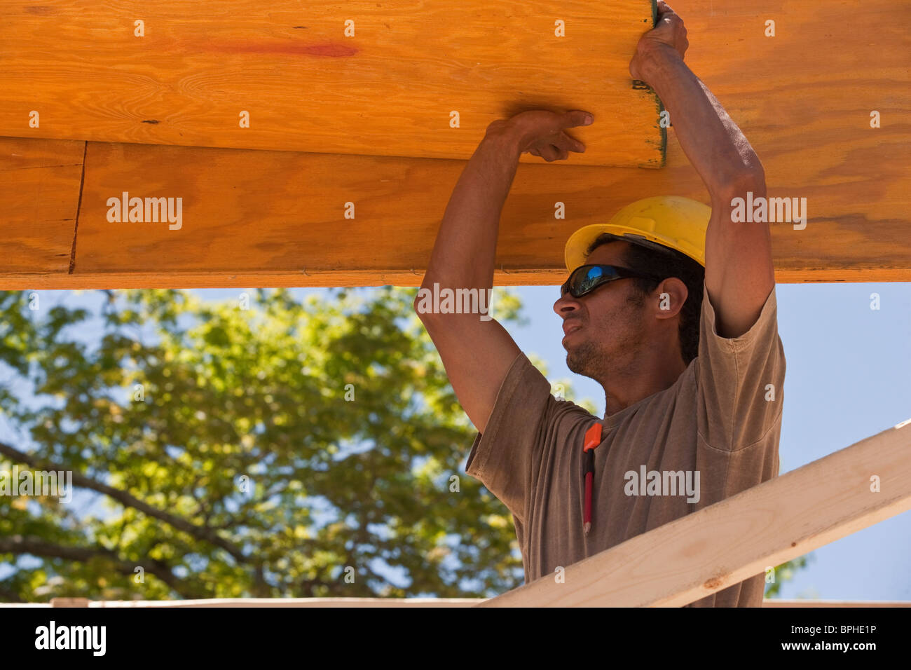 Carpenter lifting a beam Stock Photo Alamy