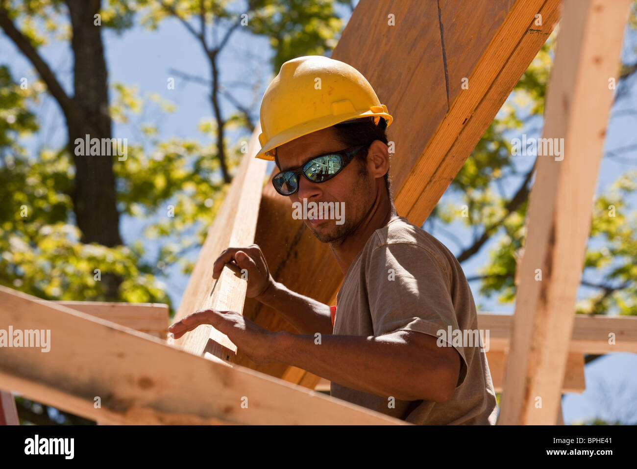 Carpenter lifting a beam Stock Photo Alamy