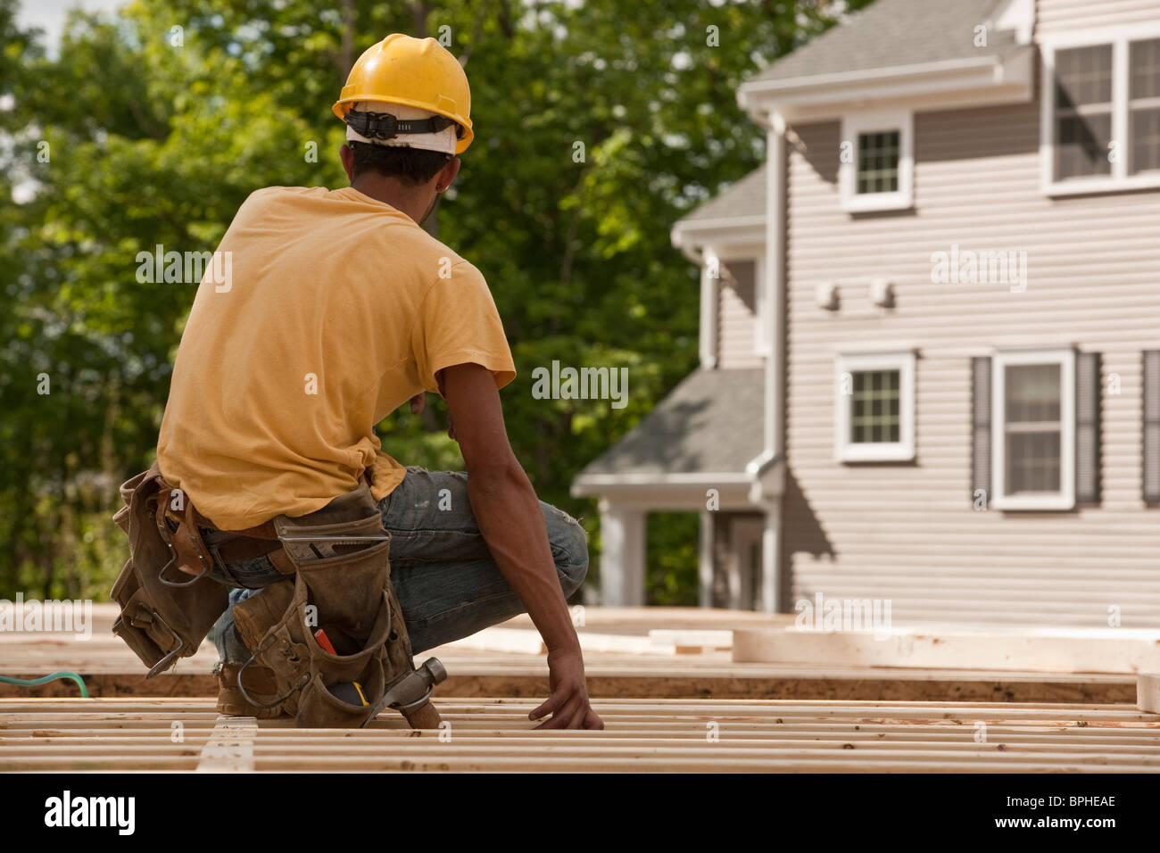 Carpenter at a construction site Stock Photo