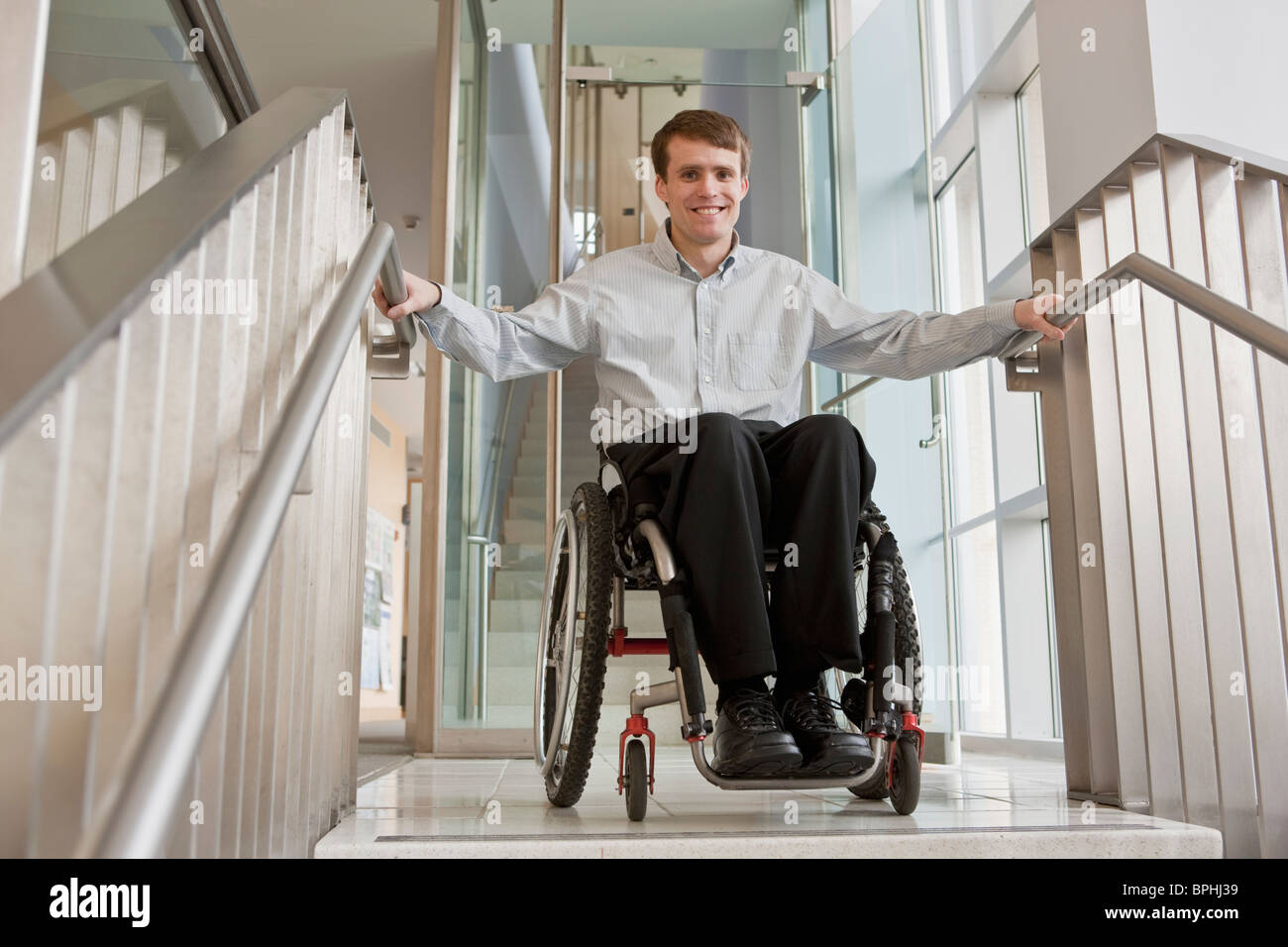 Businessman with spinal cord injury in a wheelchair at the top of