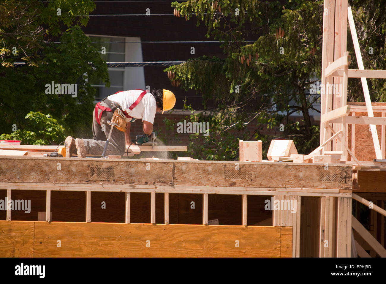 Carpenter Sawing with circular saw on second floor Stock Photo Alamy