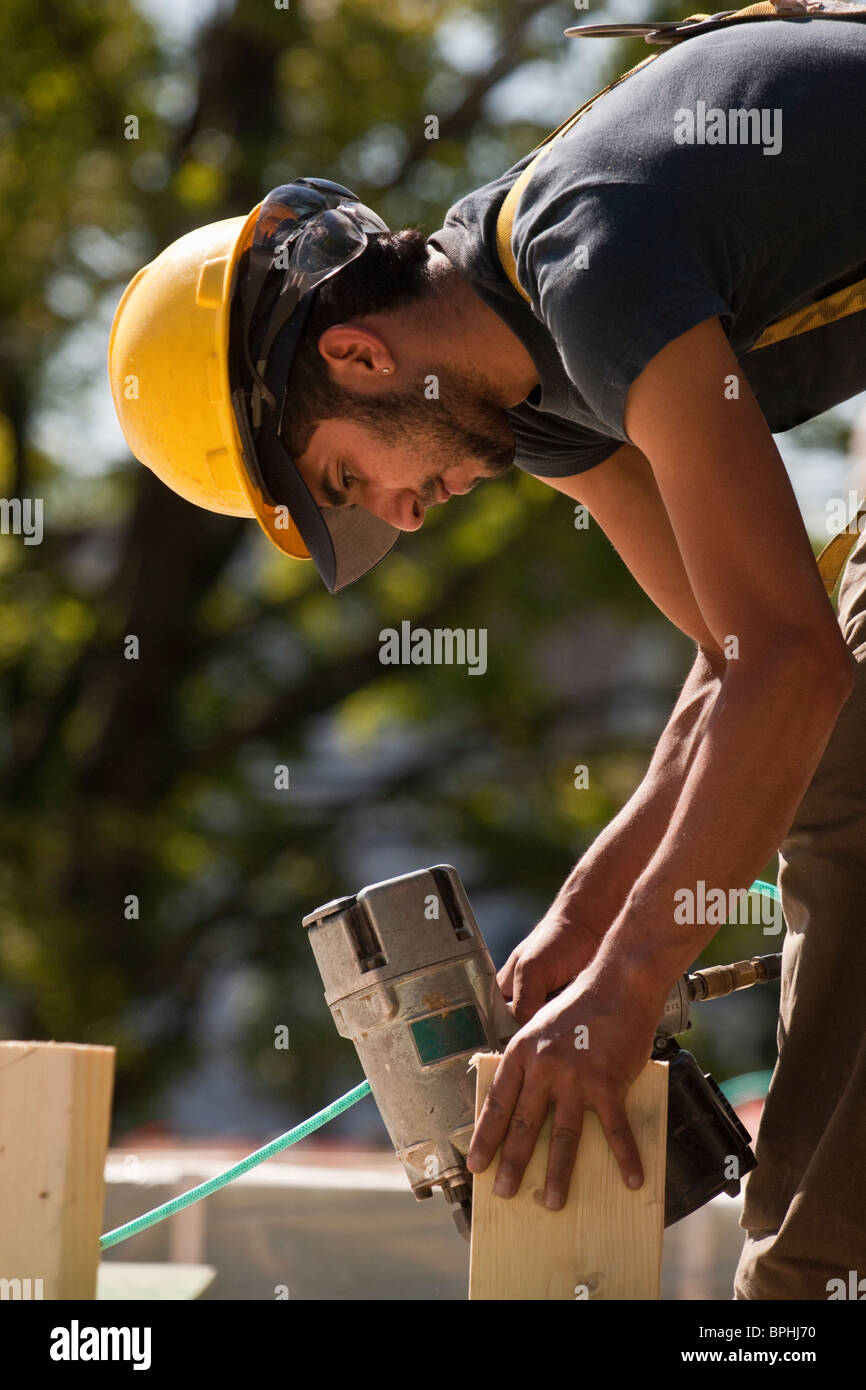 Hispanic construction worker nail gun hires stock photography and