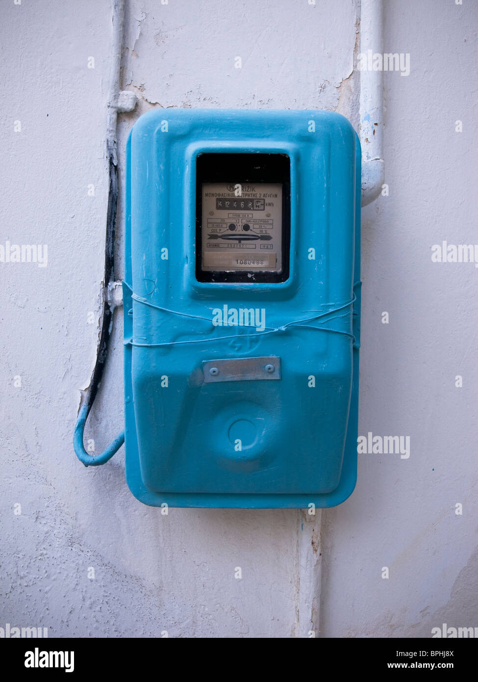 Electricity meter on wall in Greece Stock Photo