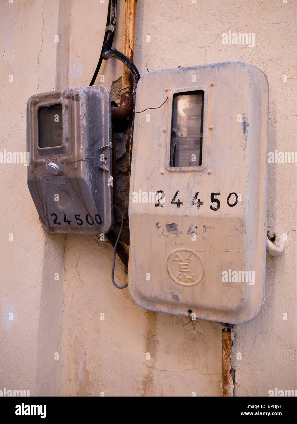 Electricity meter on wall in Greece Stock Photo