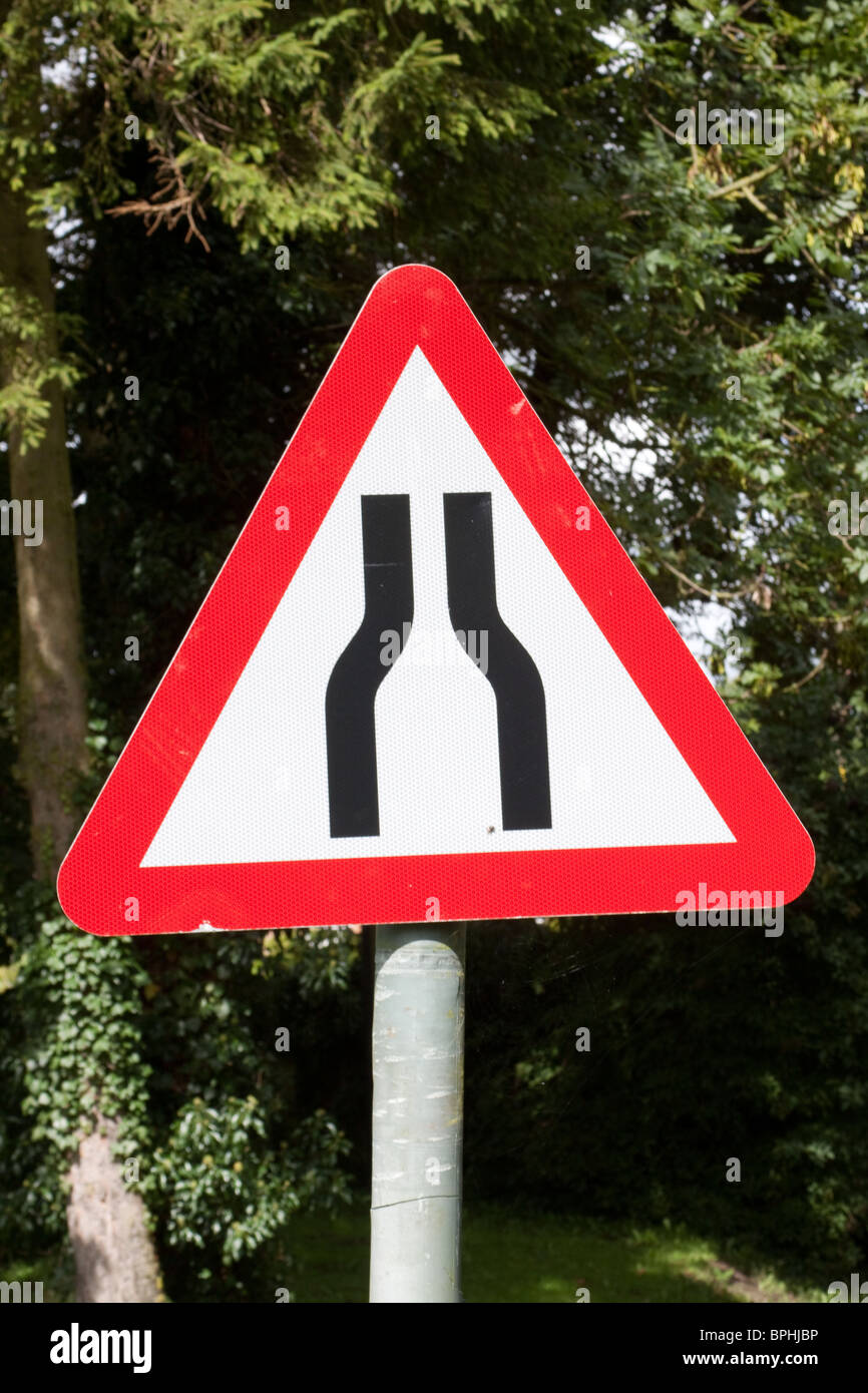 Road narrows on both sides sign Stock Photo