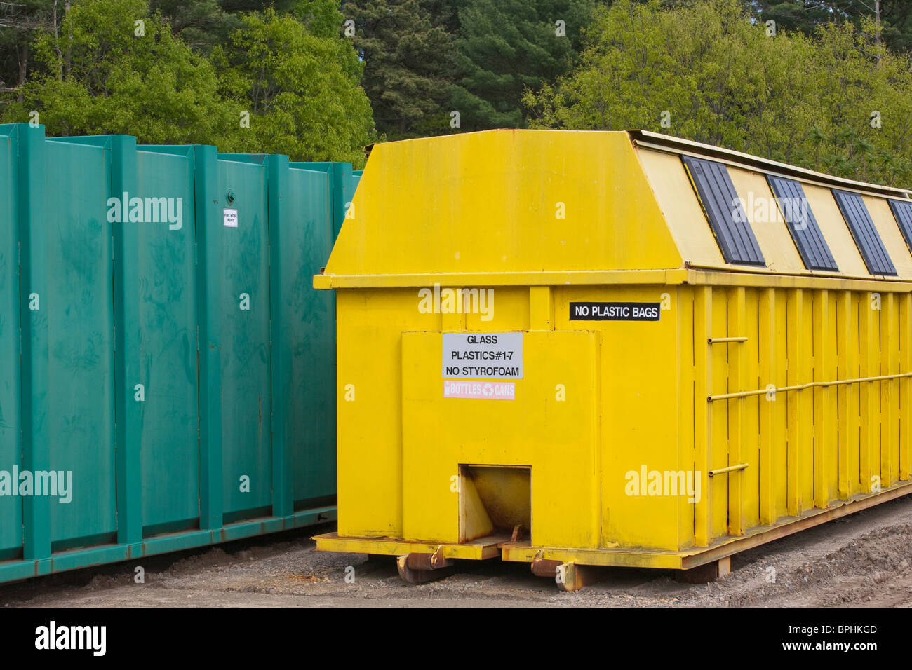 Recycling container used for plastic and glass near a trash container