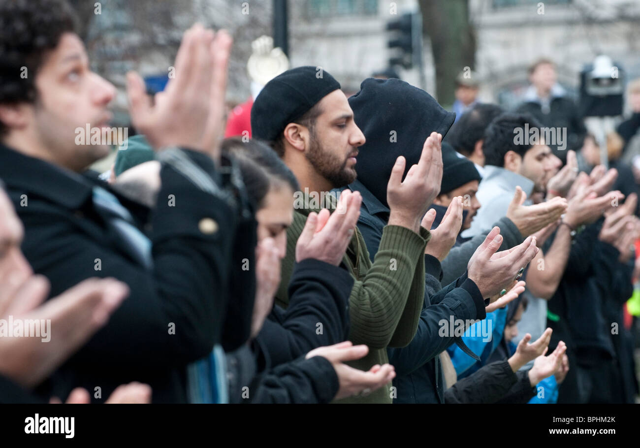 Shia Muslim men pray before  Arbaeen procession in central London UK Stock Photo