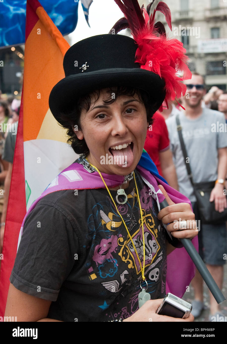 Young woman showing her tongue piercing at Gay Pride 2010 Milan Italy