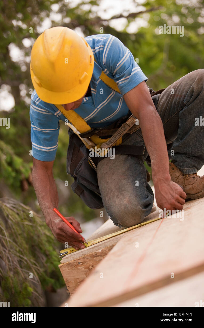 Carpenter using tape measure on flooring Stock Photo Alamy