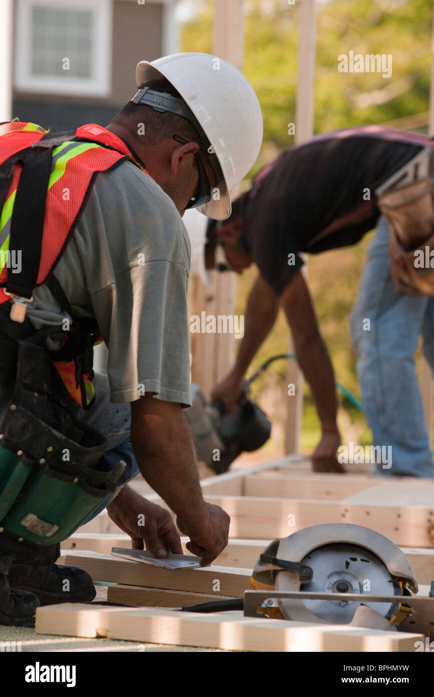 Carpenters working at a construction site Stock Photo