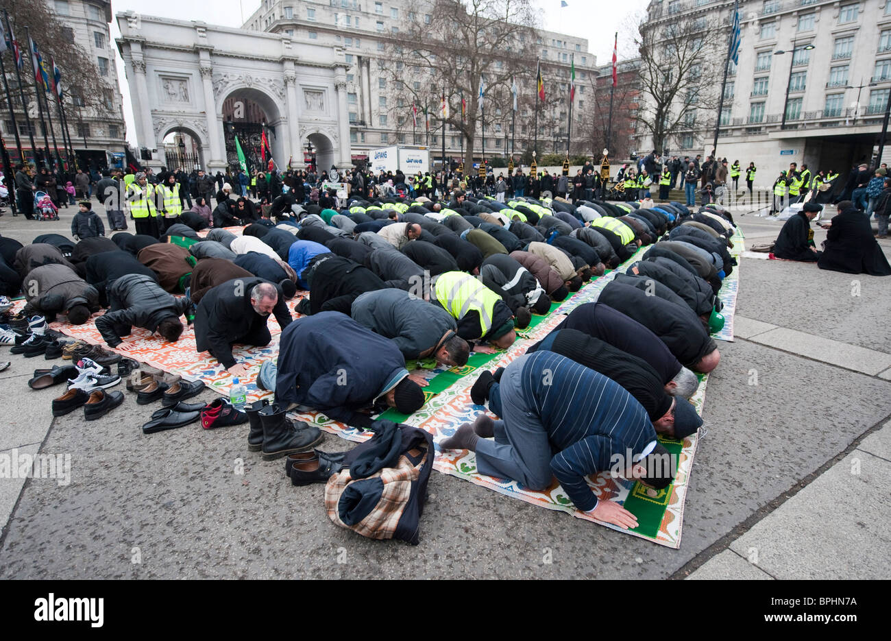 Shia muslims pray at Marble Arch ahead of Arbaeen procession in central London UK Stock Photo