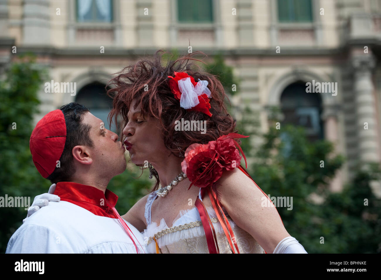 A man dressed as a priest and a man  in drag kissing at Gay Pride 2010 Milan Italy Stock Photo