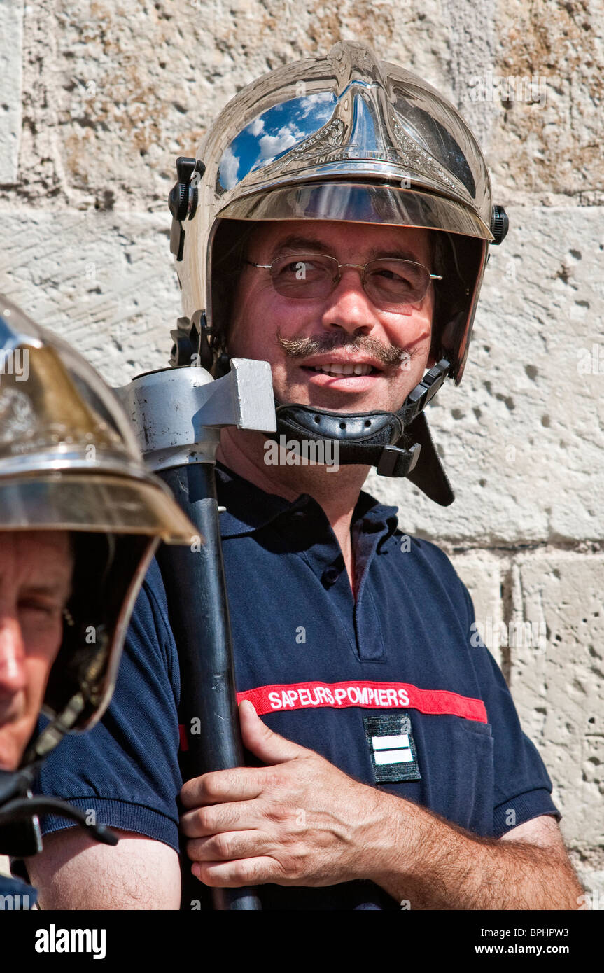 French fireman shouldering axe in guard of honor at wedding ceremony - Indre-et-Loire, France. Stock Photo
