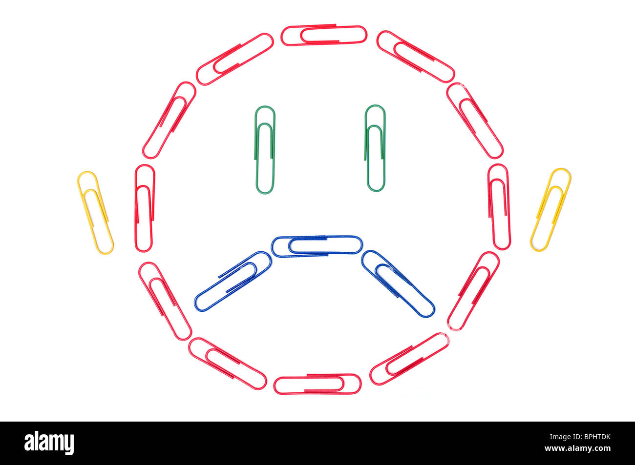 Office emoticon - sad face made up of paper clips. Stock Photo