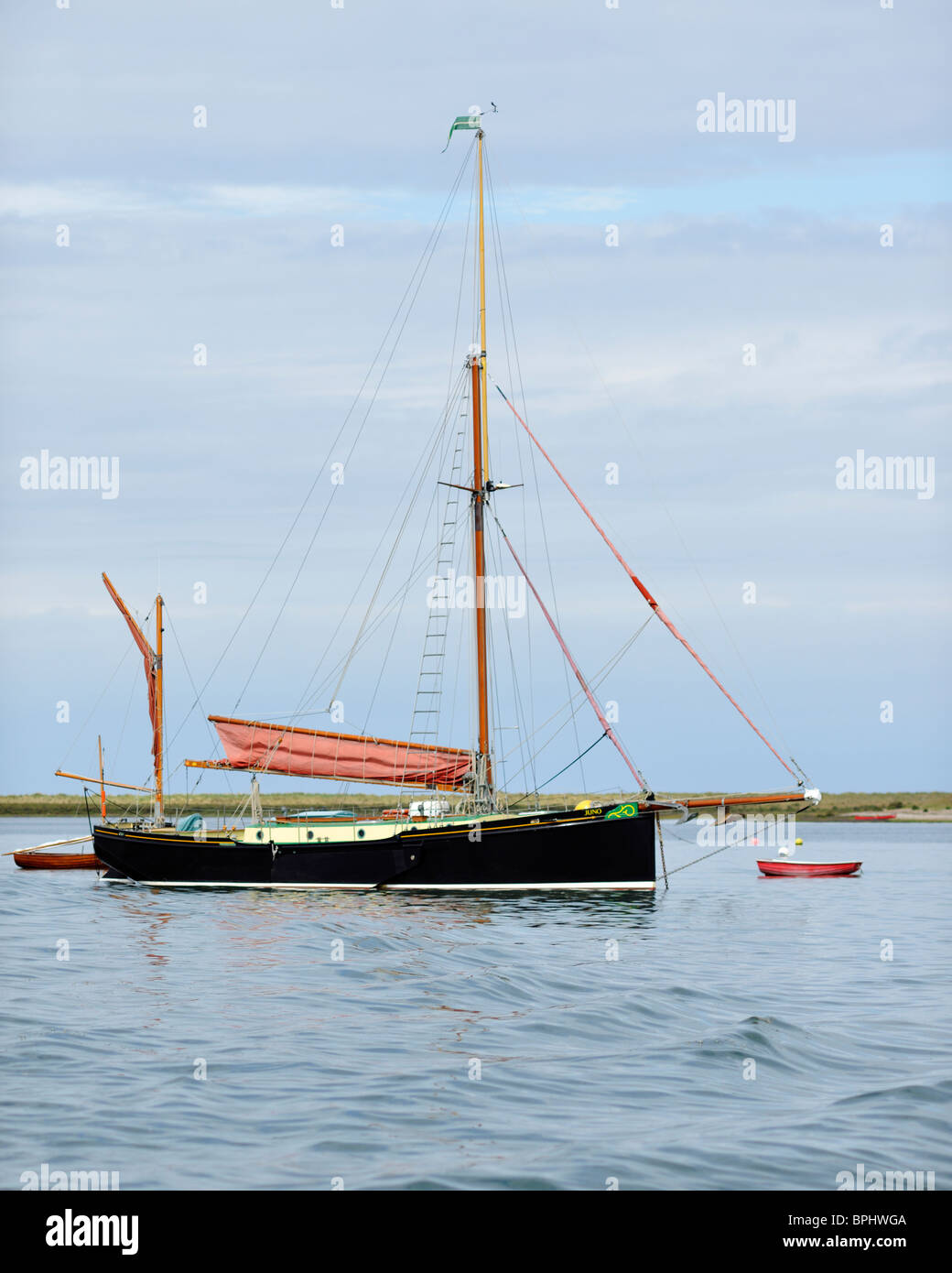 Imposing presence of a Thames barge anchored near Blakeney Point, Norfolk, England Stock Photo