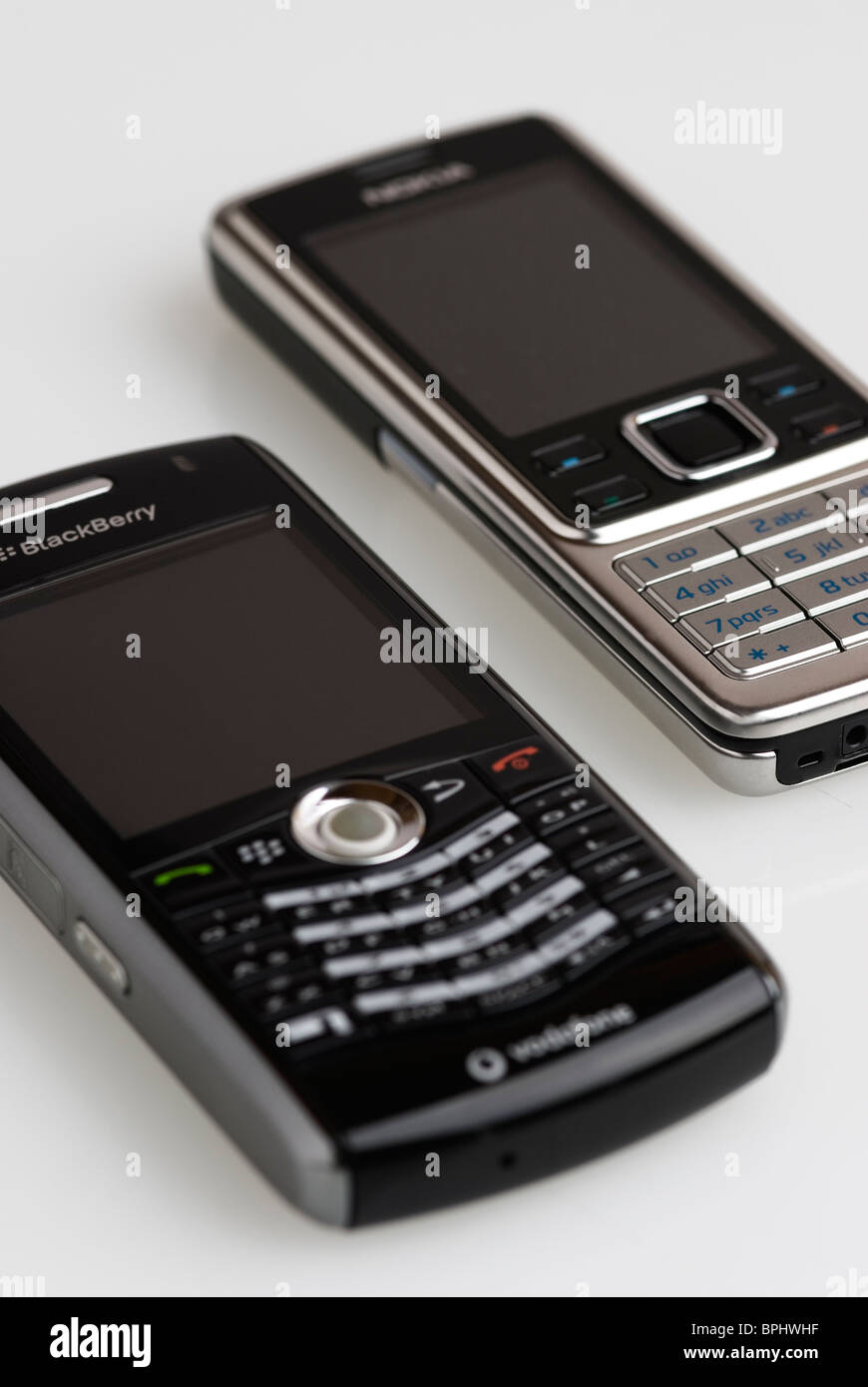 Old Blackberry and Nokia mobile phones. Stock Photo