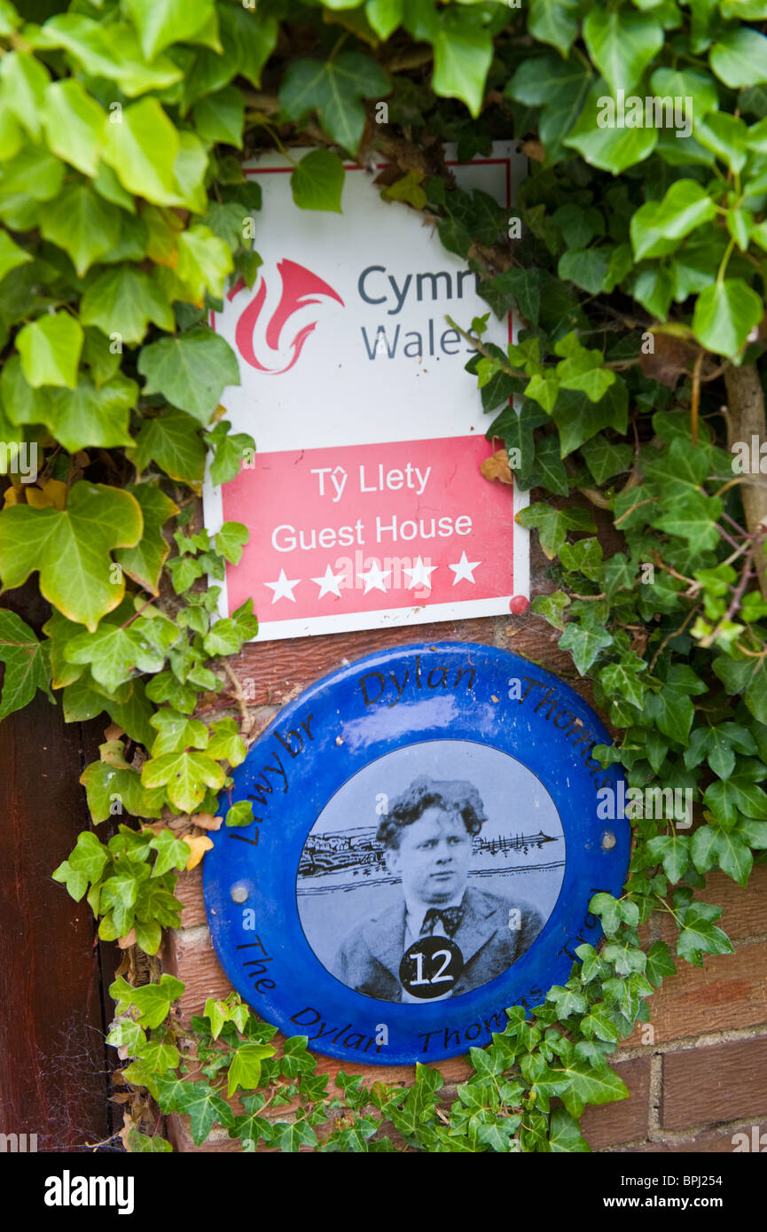 Blue heritage tourist plaque outside guest house on Dylan Thomas trail ...
