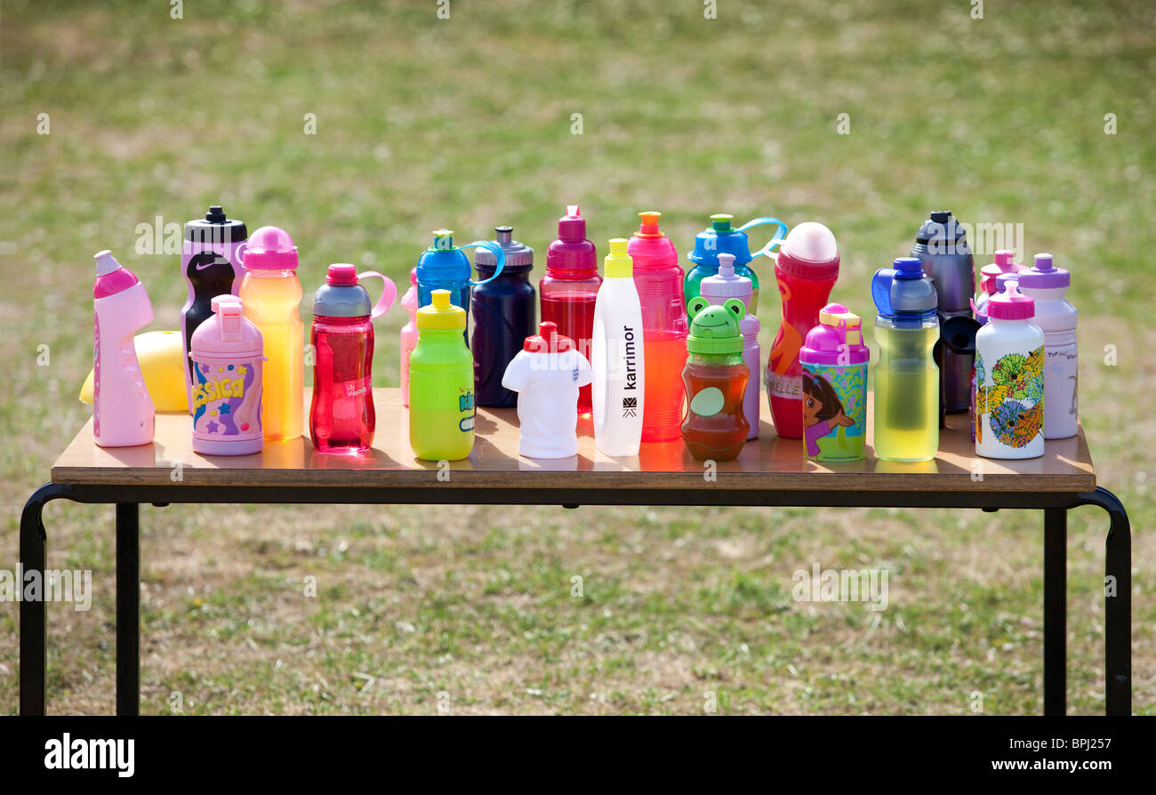 https://c8.alamy.com/comp/BPJ257/rows-of-childrens-colored-drink-bottles-on-a-table-BPJ257.jpg