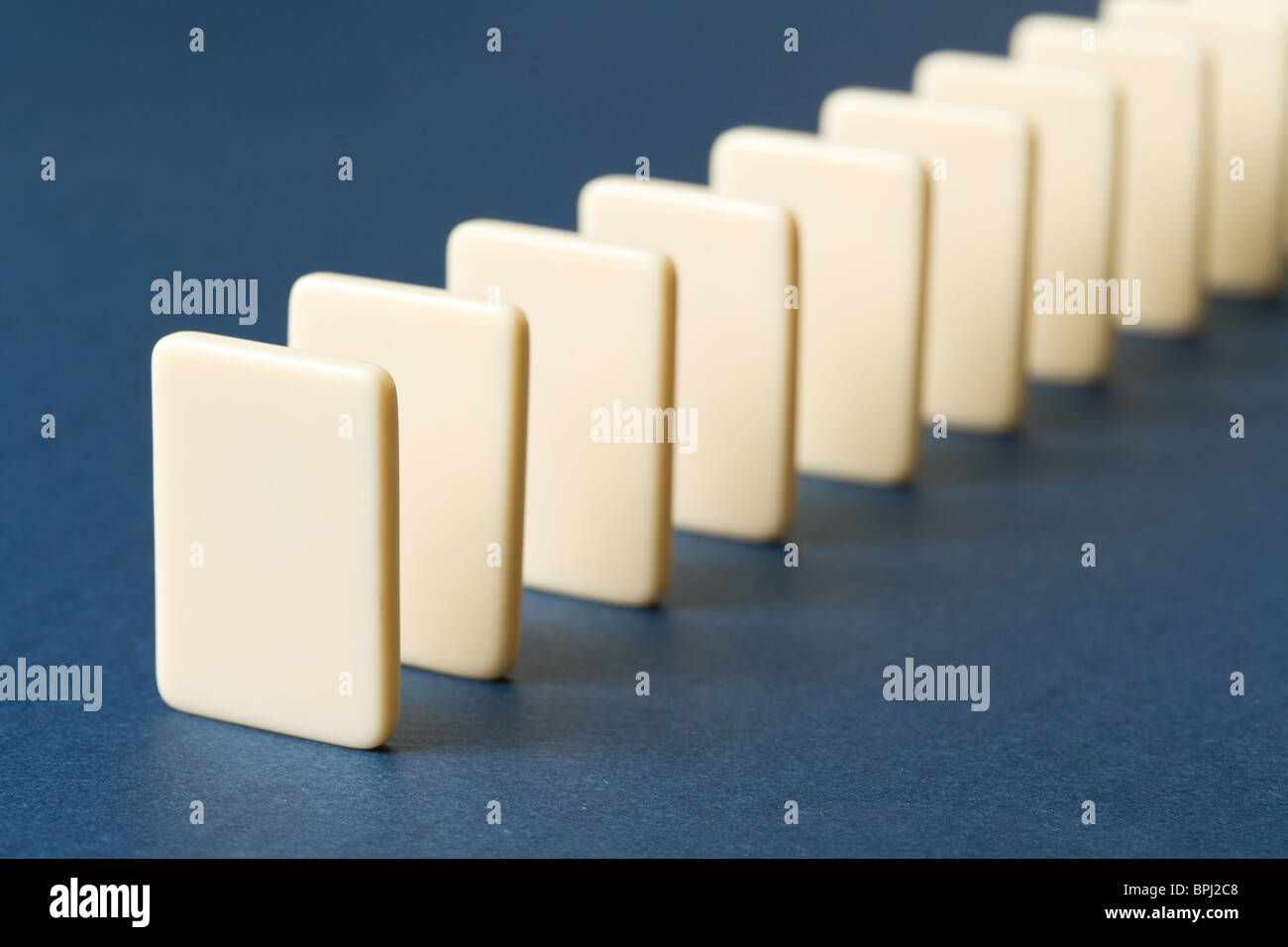 Domino with blue background, Concept of Cause or Teamwork Stock Photo