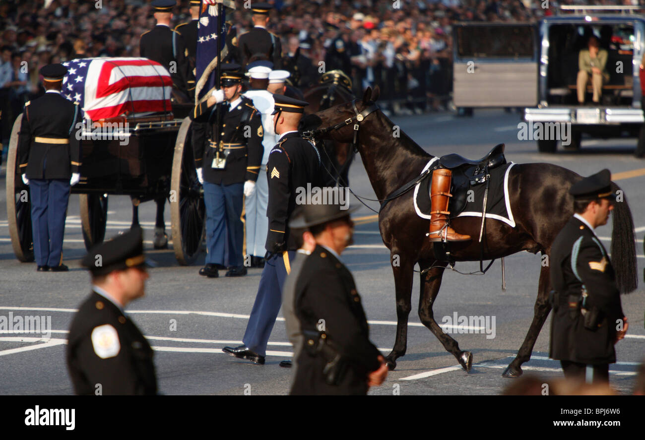 The caisson with the casket of former US President Ronald Reagan and a riderless horse with his boot during funeral procession. Stock Photo