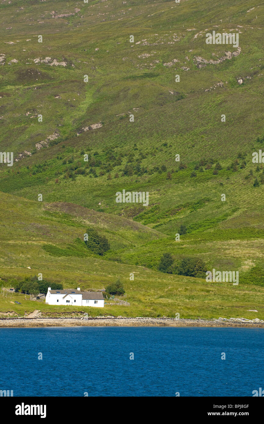 Crofters cottage on the shores of a Loch on Scalpay, Scotland Stock Photo