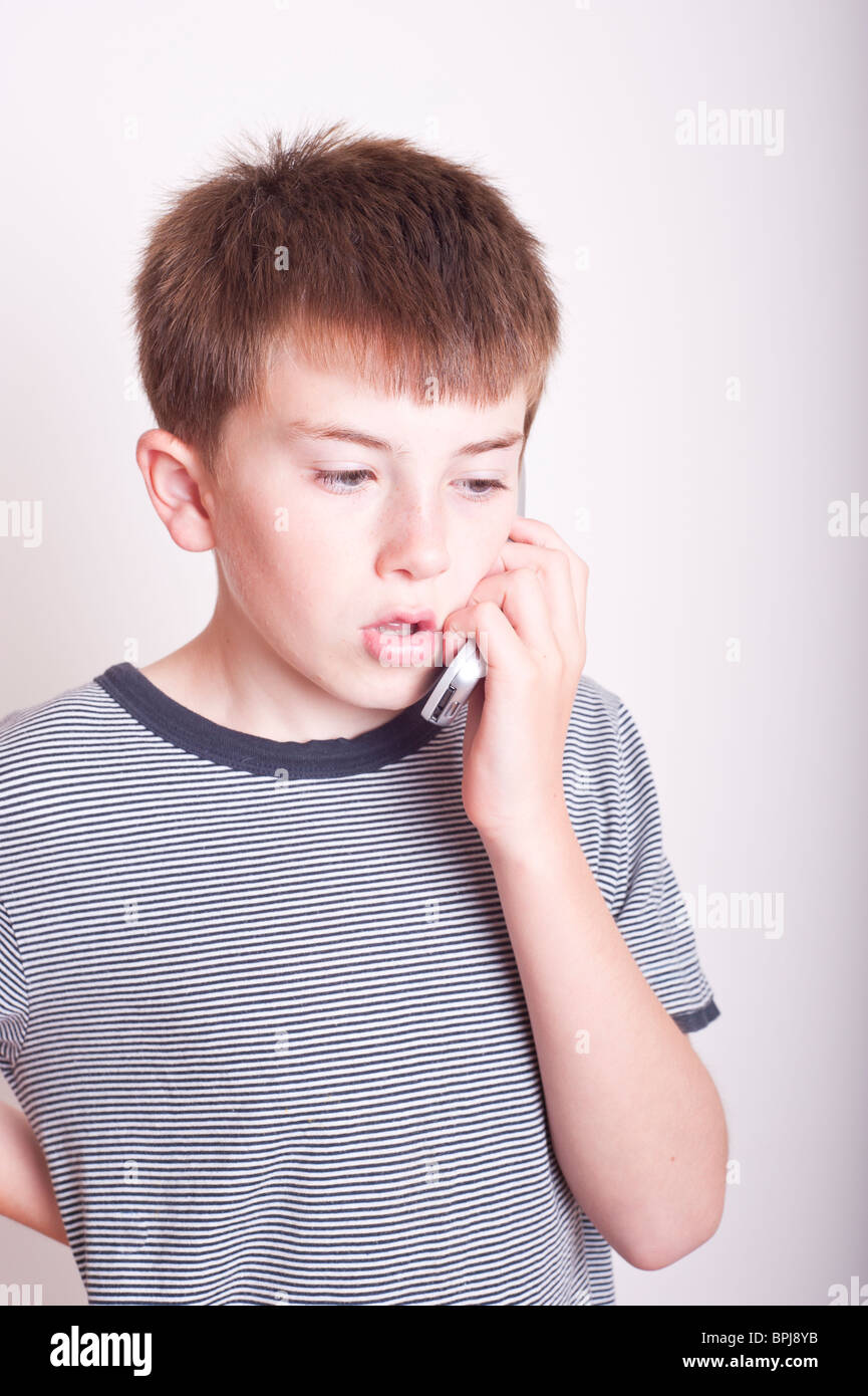 A MODEL RELEASED picture of a 10 year old boy talking on the phone in the studio Stock Photo Alamy