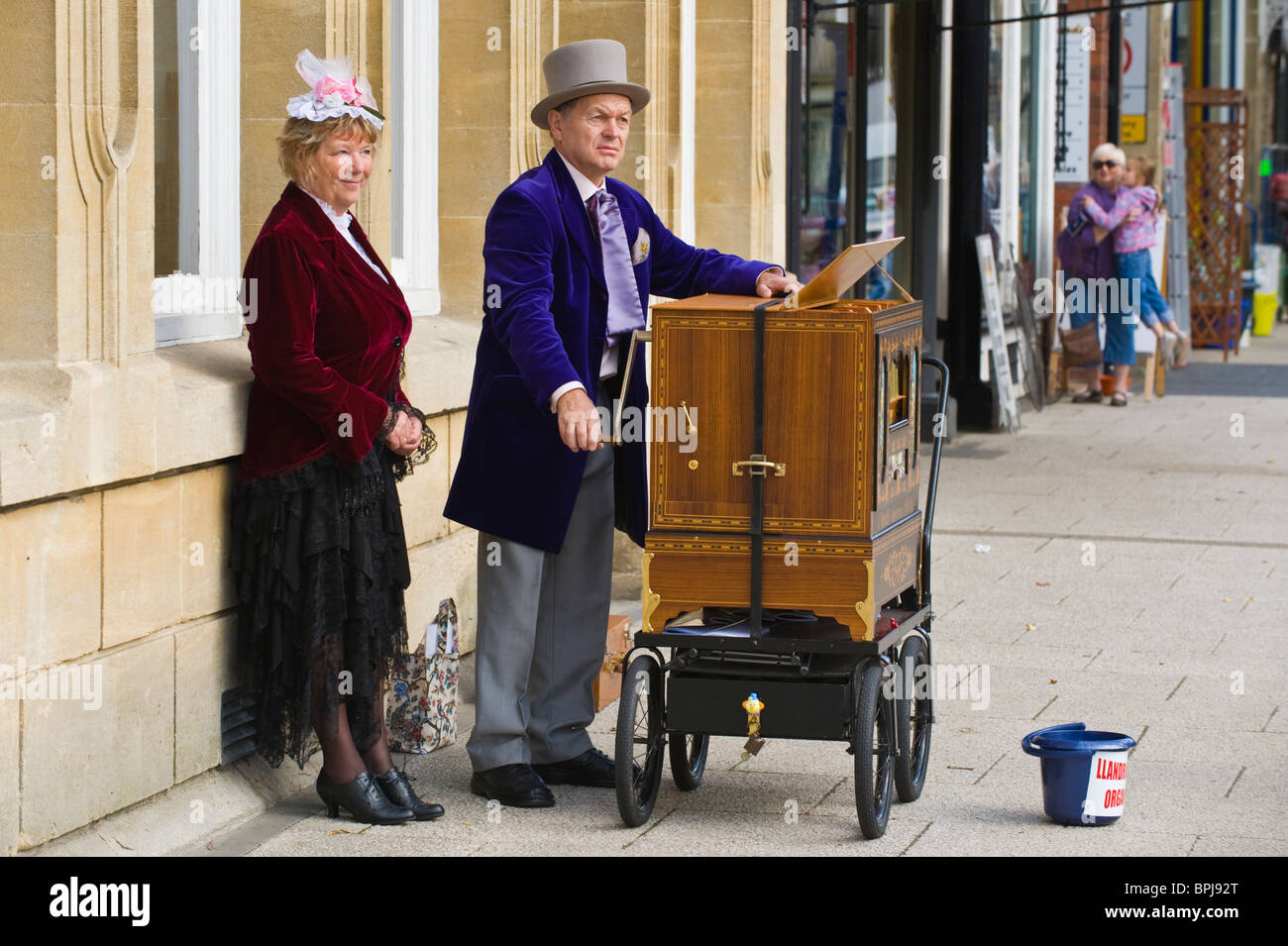 Organ grinders in period costume playing street organs at the Victorian Festival in Llandrindod Wells Powys Mid Wales UK Stock Photo