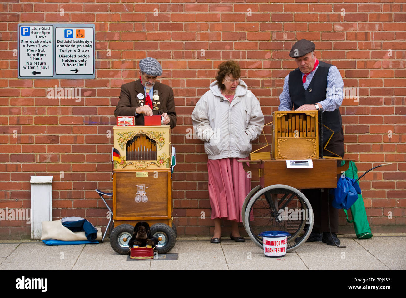 Organ grinders in period costume playing street organs at the Victorian