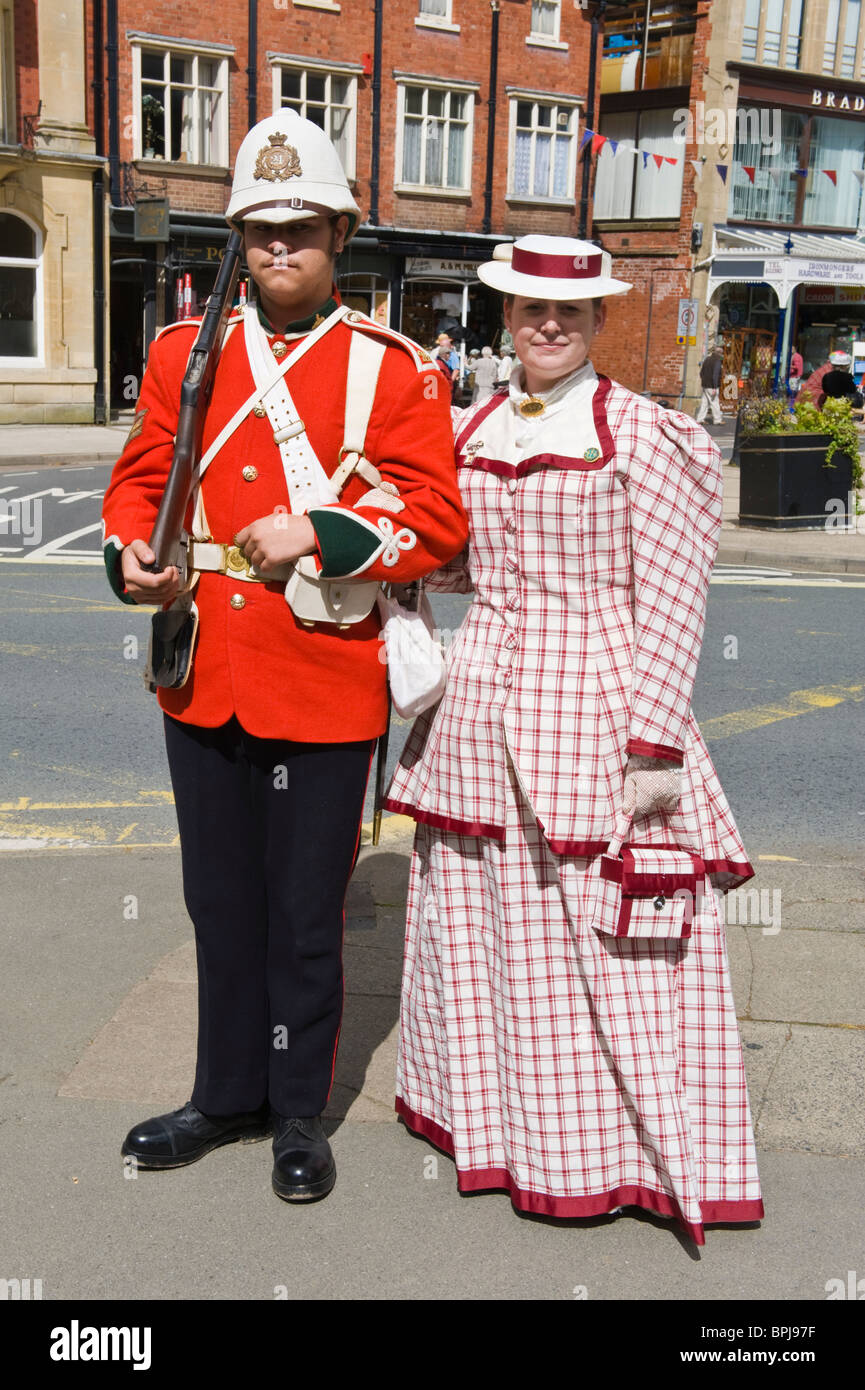 Man in period military uniform with lady at the Victorian Festival in Llandrindod Wells Powys Mid Wales UK Stock Photo