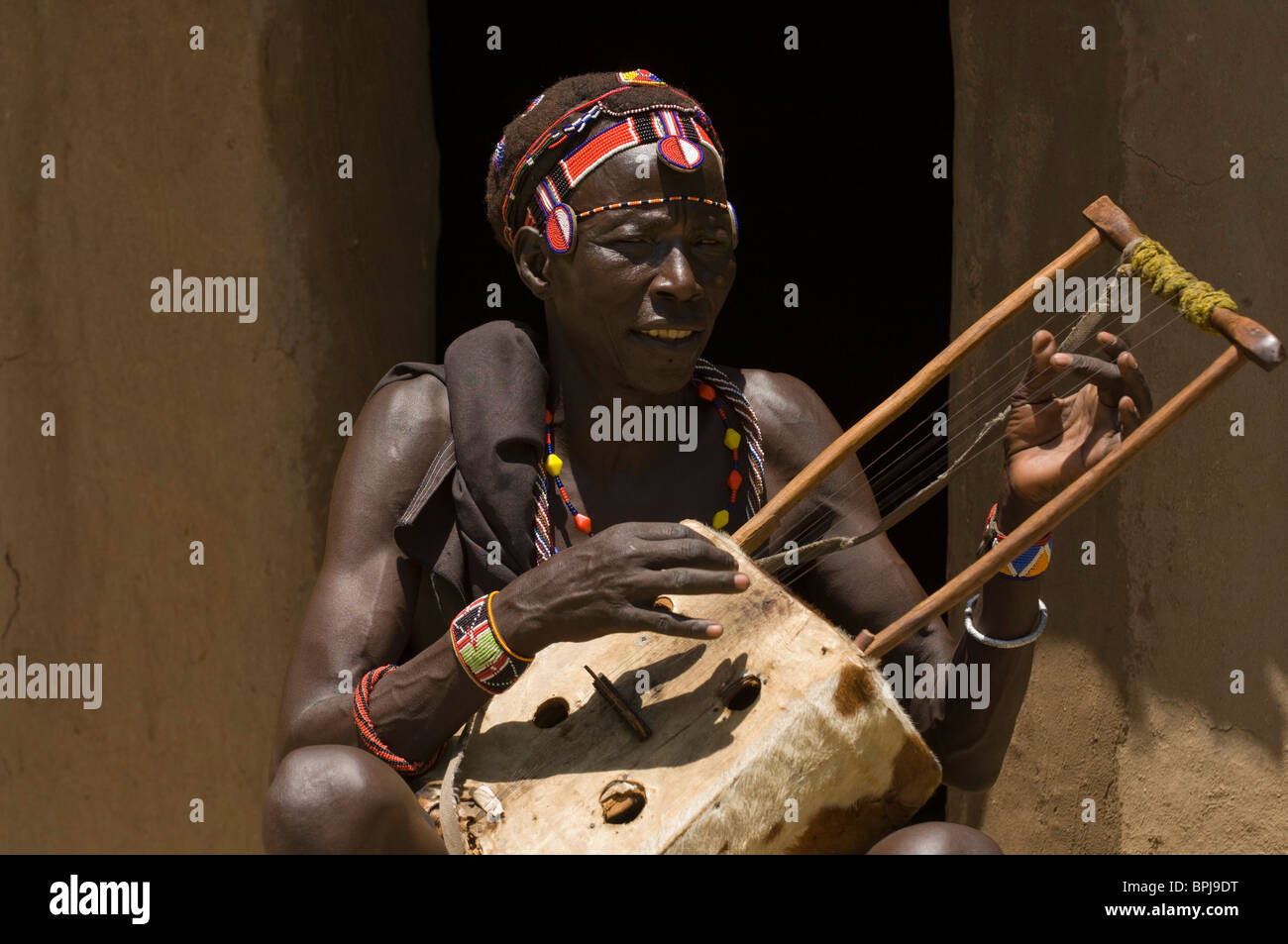 Pokot man playing a traditional instrument, Ngomongo village, Kenya