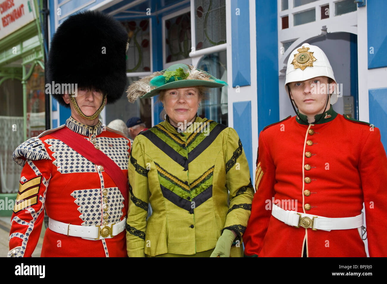 Men in period red military uniform with lady at the Victorian Festival in Llandrindod Wells Powys Mid Wales UK Stock Photo