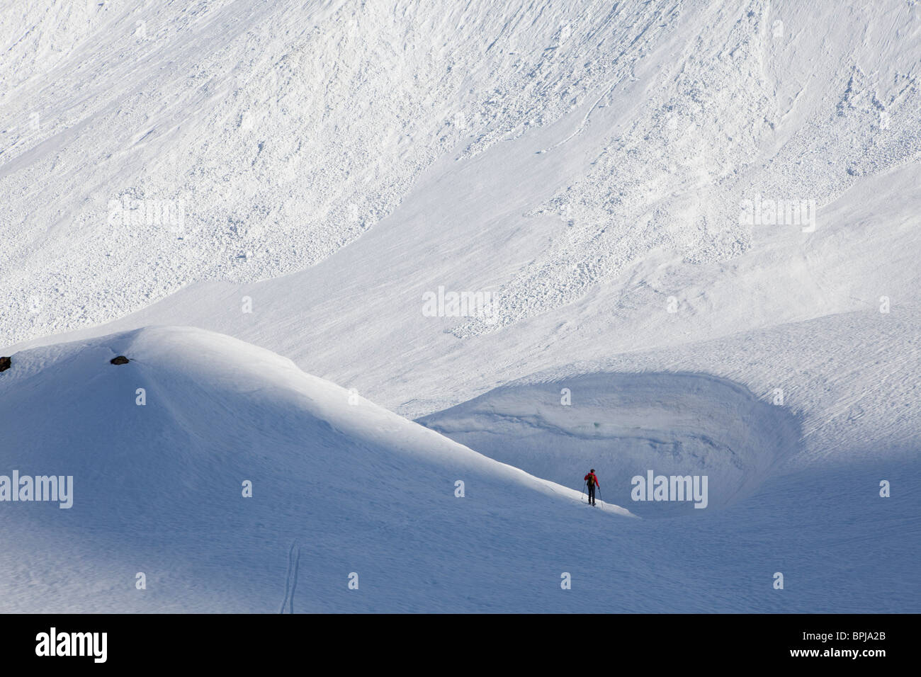 Back-country skier near snowdrift, Canton of Ticino, Switzerland Stock Photo