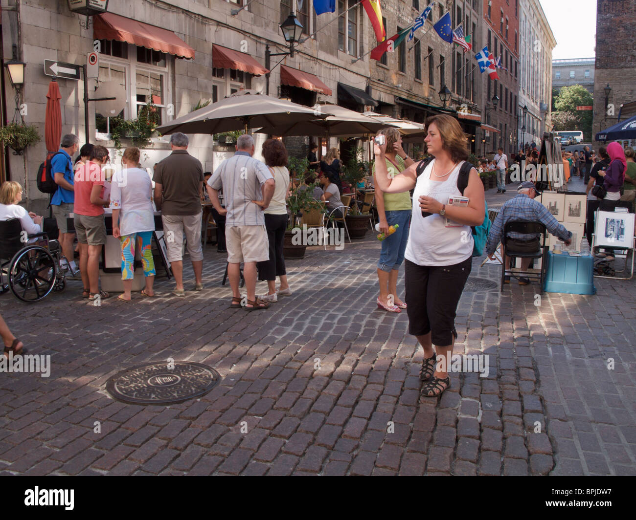 Woman taking photo on Rue St. Paul. Montreal Canada. Stock Photo