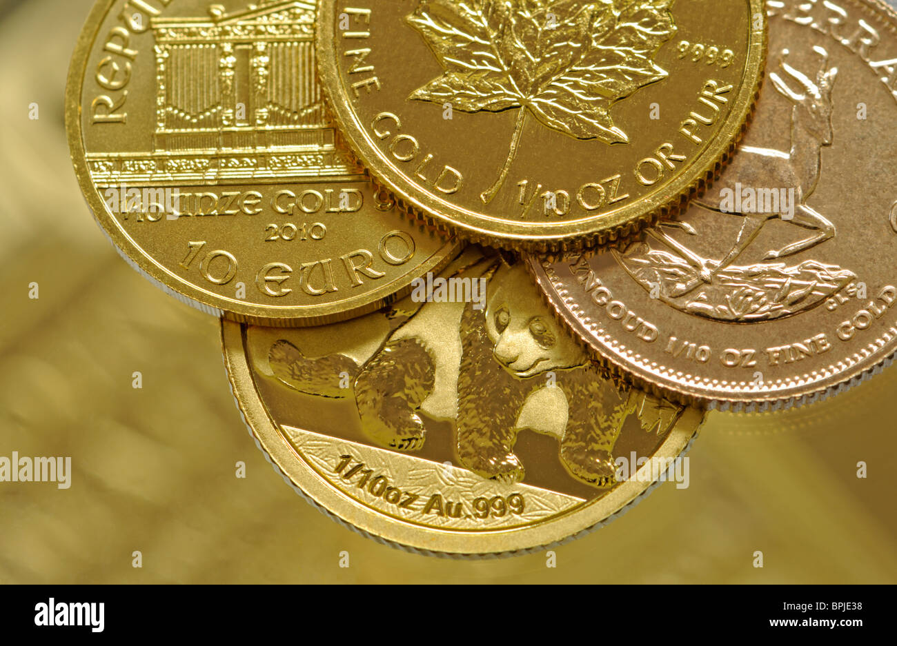 Gold Bullion 10th ounce coins - Austrian Wiener Phiharmoniker; Canadian Maple Leaf; South African 10th Krugerrand; Chinese Panda Stock Photo