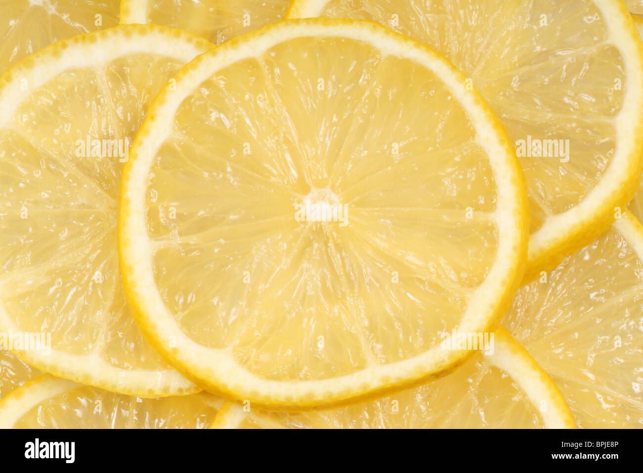 Close-up of slices of fresh lemon for an organic background. Stock Photo