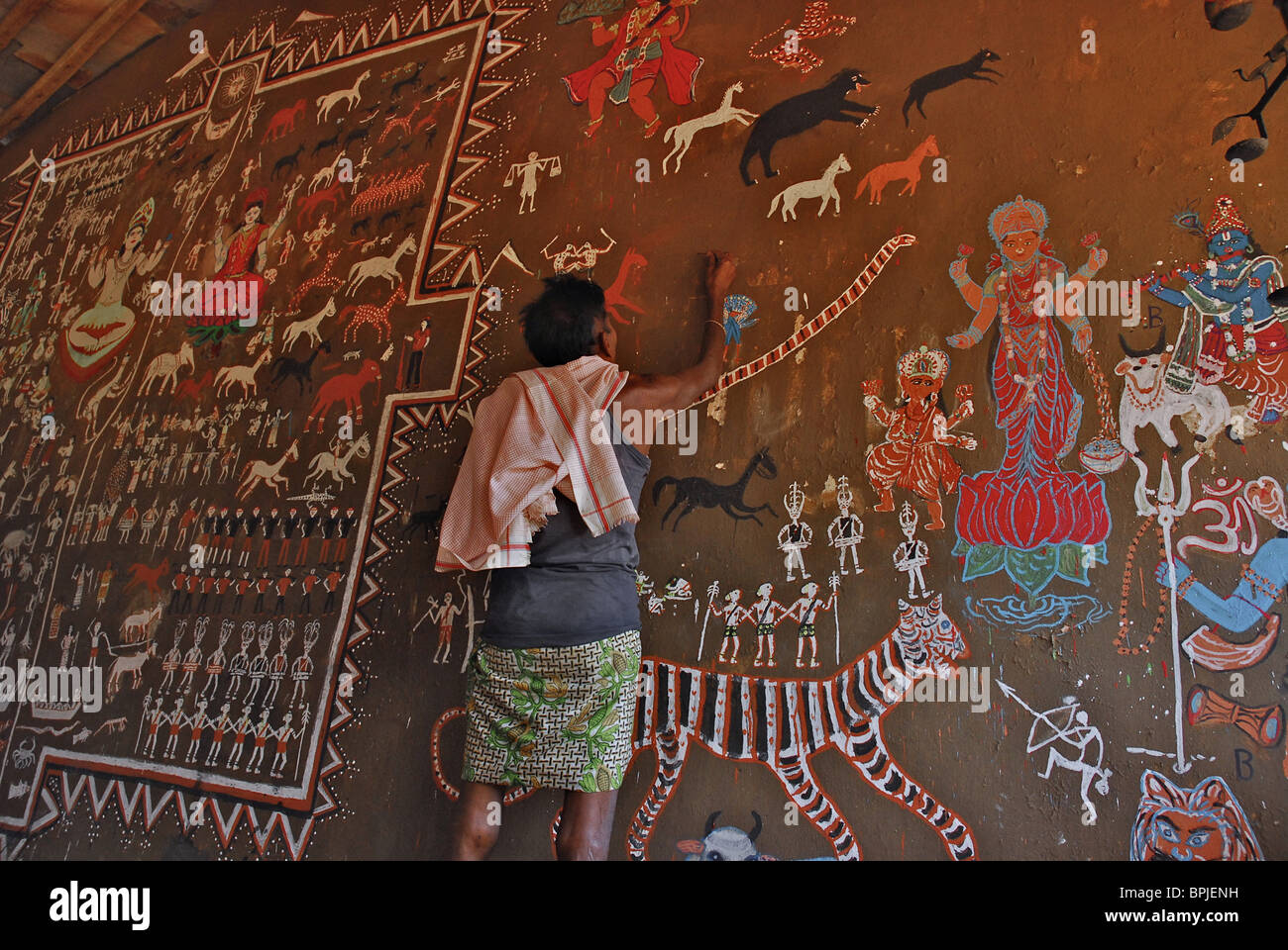 Man painting tribal art on a wall in a ceremonial hall, Bastar, Chhattisgarh, India, Asia Stock Photo