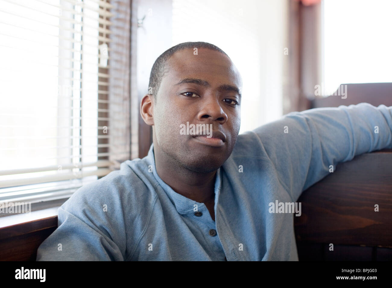 Black man sitting in booth at diner Stock Photo - Alamy