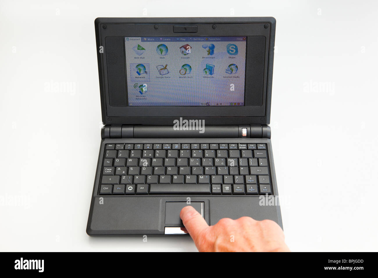 UK, Britain. Person's hand using a small Asus netbook EEE PC netbook computer running Linux operating system Stock Photo