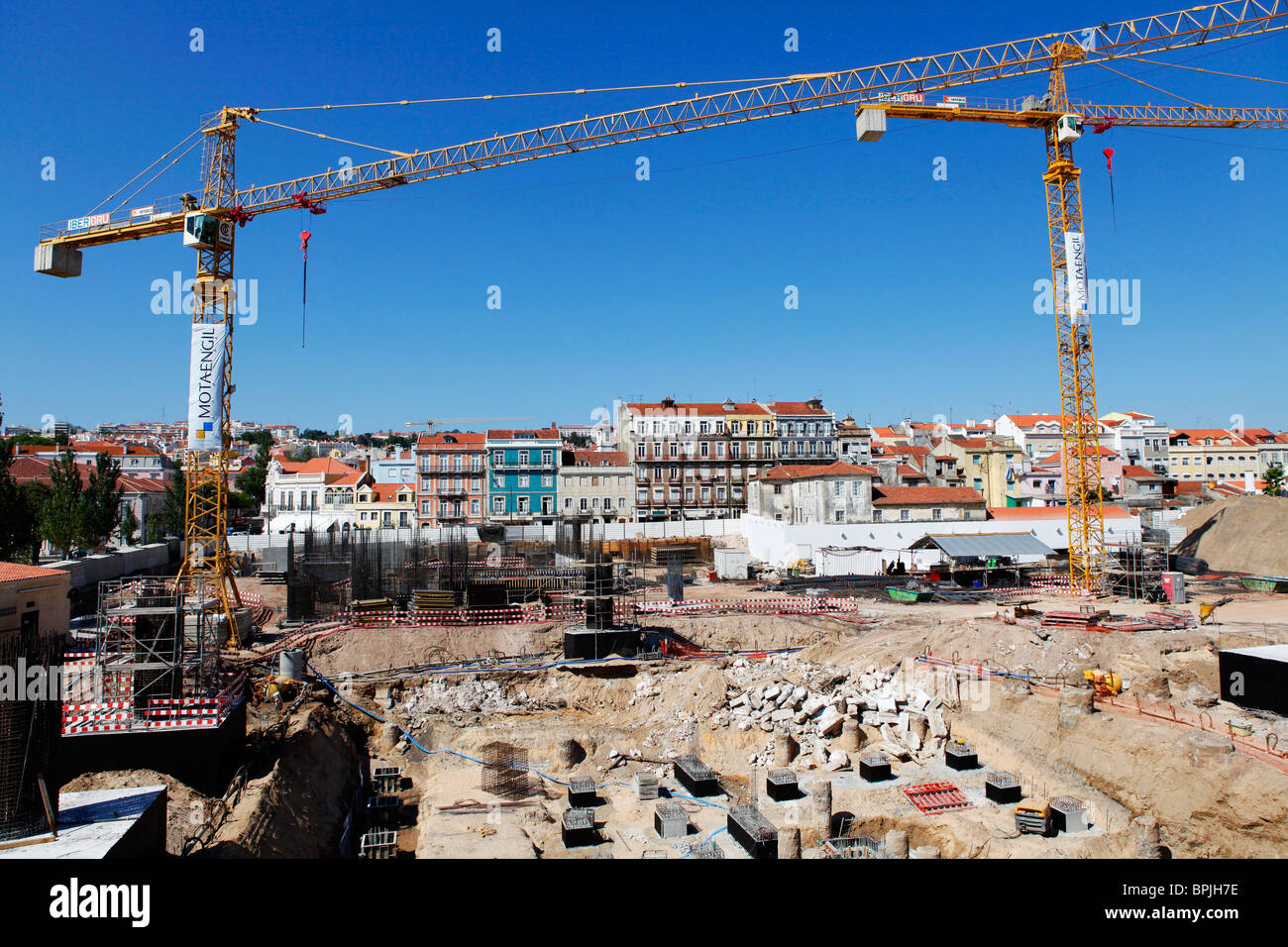 Cranes tower over a construction site in Lisbon, Portugal. Stock Photo