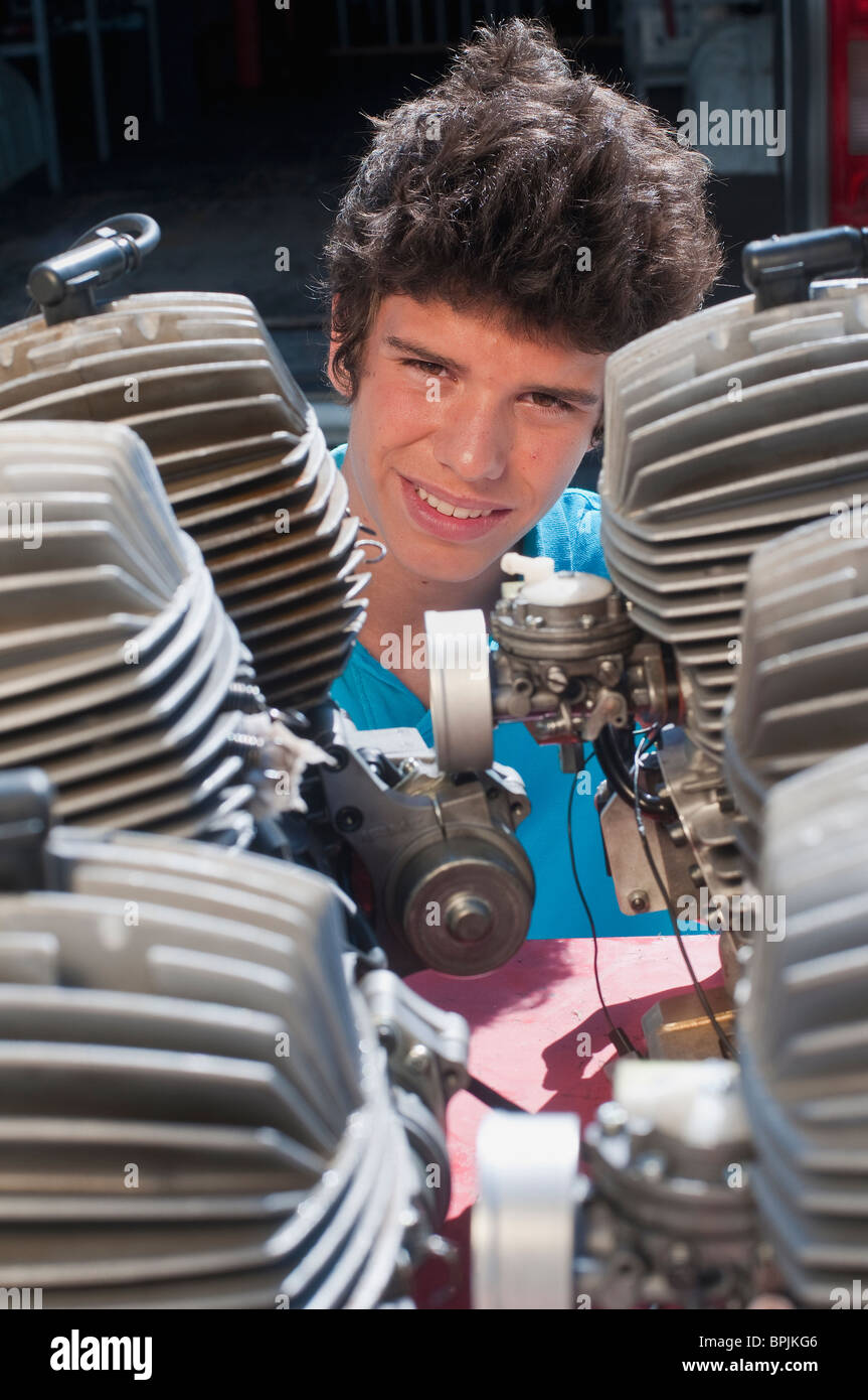 Hispanic teenager looking at engines Stock Photo