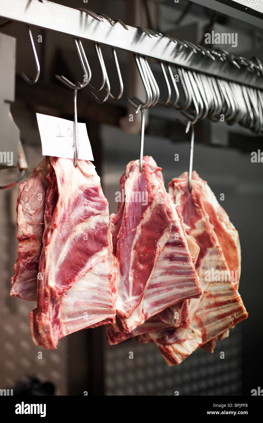 3 Chunks of beef ribs on meat hooks hanging in stainless steel kitchen or  freezer Stock Photo - Alamy
